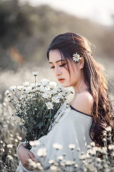 Hình ảnh cô gái mang theo một bông hoa mơ ước